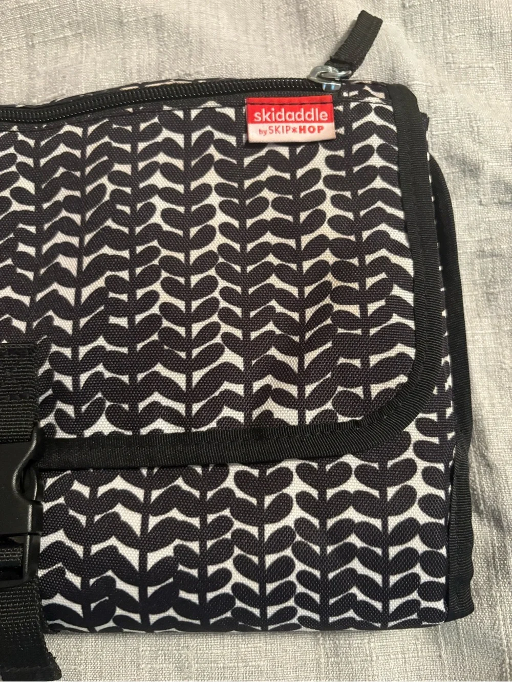 Skidaddle by Skip Hop Black & White Travel diaper bag with fold out changing pad